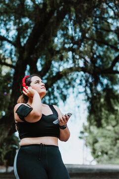 plus size young latin woman running in park in Mexico
