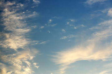 Naklejka na ściany i meble Beautiful white clouds in blue sky at sunset