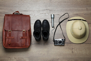 Flat lay composition with different safari accessories on wooden background © New Africa