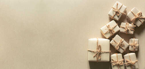 brown gift on gray background,Gift box wrapped in craft paper with gold ribbon and stars on grey stone