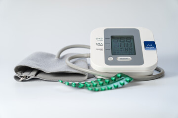 Blood pressure monitor to take blood pressure and pills to lower it.