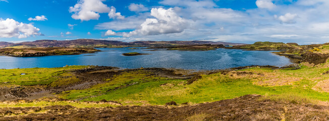 Fototapeta premium A panorama view across islets on Loch Dunvegan on the island of Skye, Scotland on a summers day