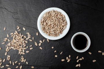 Sunflower seeds and soy sauce pot on a black stone