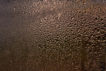 wet window glass with splashes and drops of water. horizontal
