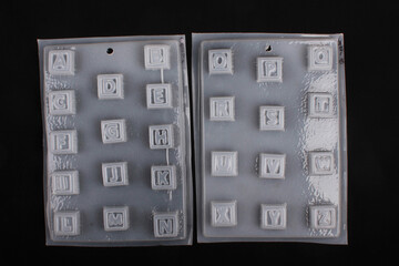 Alphabet shape white thermoformed plastic molds for chocolate, soap or jelly