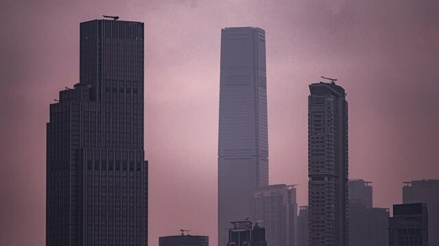 Sky 100 and Kowloon skyscrapers timelapse at sunset