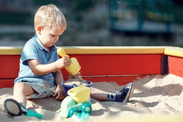 Small boy playing in a sand box