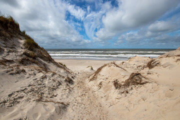 Path to the beach through dunes