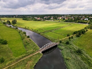 Bridge over the river, countryside, fields, meadows seen from above 