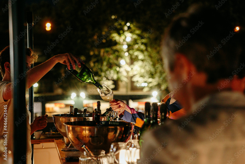 Wall mural pouring into glasses at a cocktail, in paris