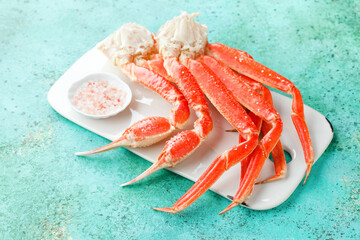 Boiled crab legs on a ceramic serving board, selective focus - Powered by Adobe
