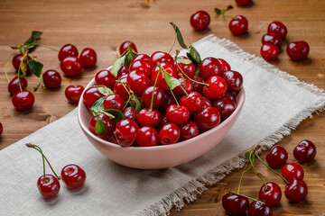 Fresh organic sour cherries on wooden background
