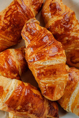 Warm fresh Croissants with butter close-up. Texture French croissants with a golden crust. Food background