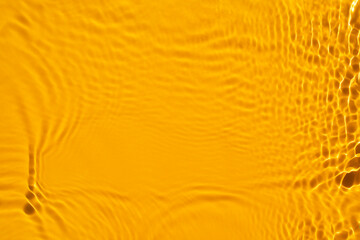 Aqua waves on orange background. Light and shadows. Water spills on a light orange background. Natural sunlight and shade.  Summer mood