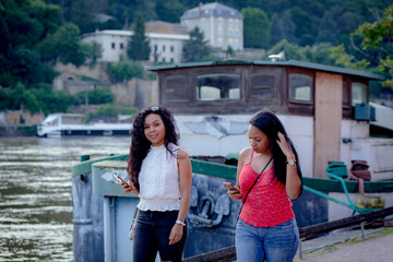 couple of young women with smart phone in lyon france