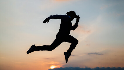 silhouette of man running in sense of freedom on sunrise sky, stamina