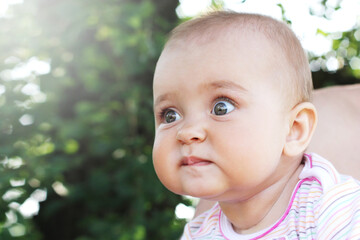 Cute cheerful infant baby girl outdoors