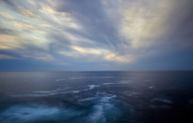 Obraz premium calm horizon with clouds that move quickly in the sky and a sea with areas of water foam and currents