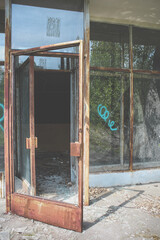 Broken open glass door. Abandoned building in Pripyat