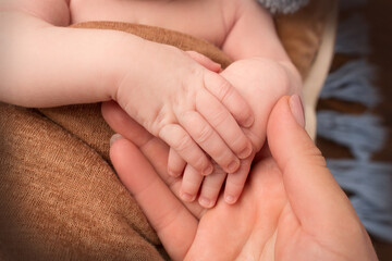 Obraz na płótnie Canvas Newborn baby holding mother's finger, Close up photo of hands of newborn baby and woman.