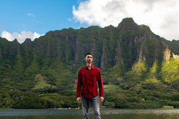 Man standing in front of Hawaii mountains