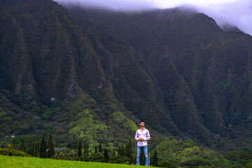 Man standing in front of mountains in Hawaii 