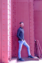 Man modeling standing on red Golden Gate Bridge 