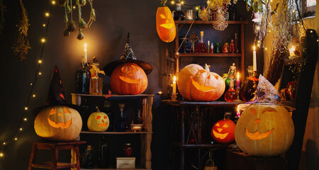 Halloween pumpkins with lights and  burning  candles and magic potions in witch's house
