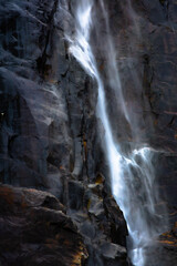 Beautiful waterfall against black rocks
