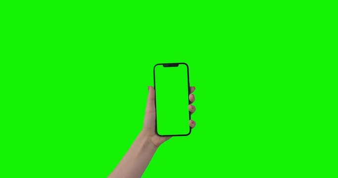 Point of View of Woman with Pink Manicure Using Phone With Green Mock-up Screen. iPhone 12 Pro Max Isolated on Chroma Key. Surfing Internet Watching Content Videos Blogs. Alpha Channel.
