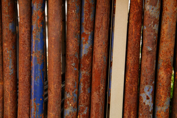 industrial background made of the texture of old painted rusty pipes