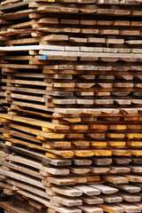 industrial background made of old wooden pallets stacked in a pile