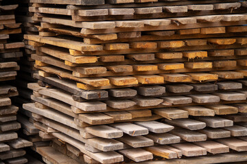 industrial background made of old wooden pallets stacked in a pile