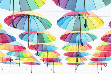 Multi-colored umbrellas weigh in several rows