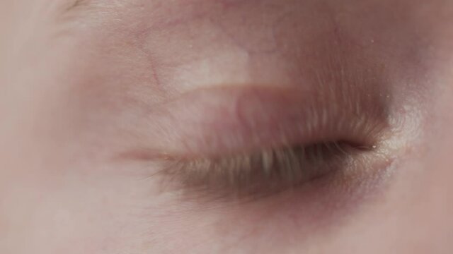 Unrecognizable female putting in contact lens