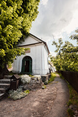 Church in The Spania Dolina village with mining landscape, Slovakia, Europe. - obrazy, fototapety, plakaty