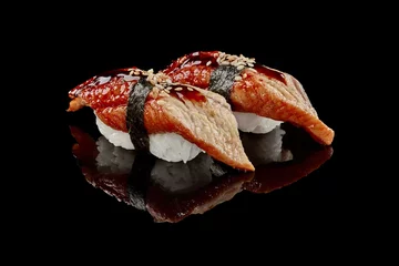 Selbstklebende Fototapeten Two nigiri sushi with eel, unagi sauce and sesame © nazarovsergey