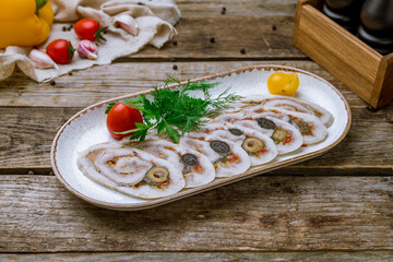 sliced chicken roll on plate on old wooden table