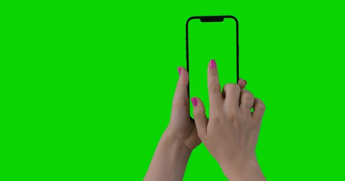 Woman hand holding the smartphone on green screen chroma key background. Bonus 20 Gestures Set. Phone mock-up for your product. iPhone 12 Pro Max in vertical orientation portrait mode. Alpha Channel.