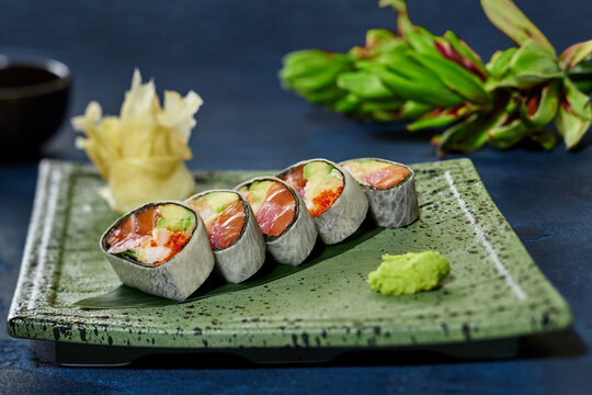 Sushi rolls with tuna, salmon, crab meat, tobiko and avocado in mamenori