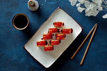 Top view of Philadelphia rolls with salmon, red caviar and unagi sauce