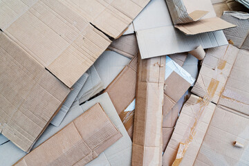 Lots of waste from various old cardboard packaging boxes. There are pieces of different shapes and colors, scotch remains. Background. Texture.