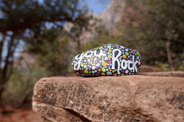 Rock ledge with kindness rock having painted you rock message 