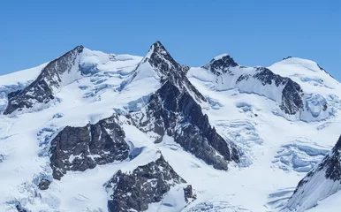 Fotobehang The peaks of Monte Rosa covered by glaciers near the village of Zermatt, Switzerland - June 2021 © Roberto