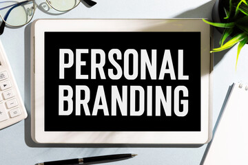 Text PERSONAL BRANDING on tablet, calculator, glasses. Business concept. Flat lay.