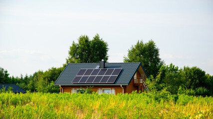 ecological wooden house with solar panels on a sunny day