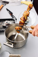 The kebab is removed from the skewer