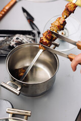 The kebab is removed from the skewer