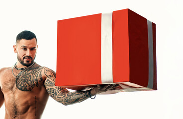 Sexy man with presetn box. big shopping sale. brutal sportsman torso. steroids. sport and fitness, health. muscular macho man with athletic body. confidence charisma. sexy abs of tattoo man.
