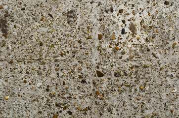 Grey rustic concrete wall background with small pebble. Ground stone for design with copy space